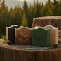 Masculine Bar Soap - Four bars on rustic wood with golden hour wilderness background